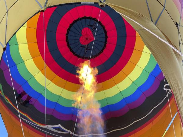 The flame of a gas burner helps inflate a hot air balloon.